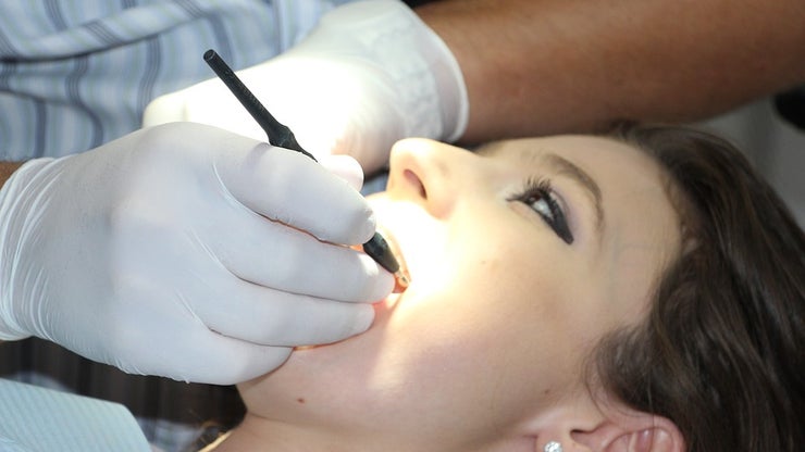 Woman having her teeth examined by a dentist